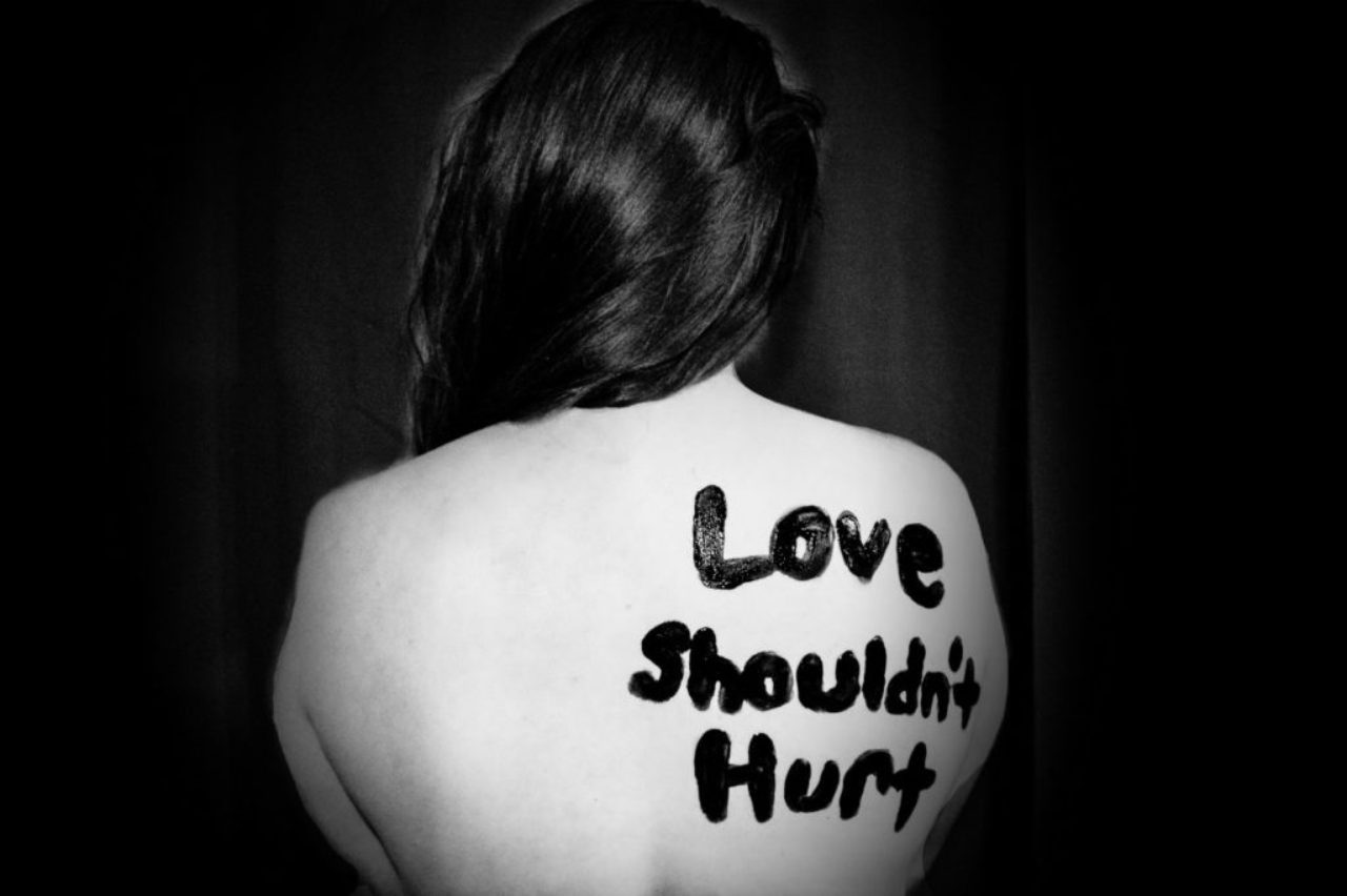 sydney-sims-521161-unsplash-bw-love-shouldn't-hurt-on-womans-bare-back