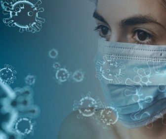 female-wearing-surgical-mask-surriunded-by-graphic-coronavirus-4914026
