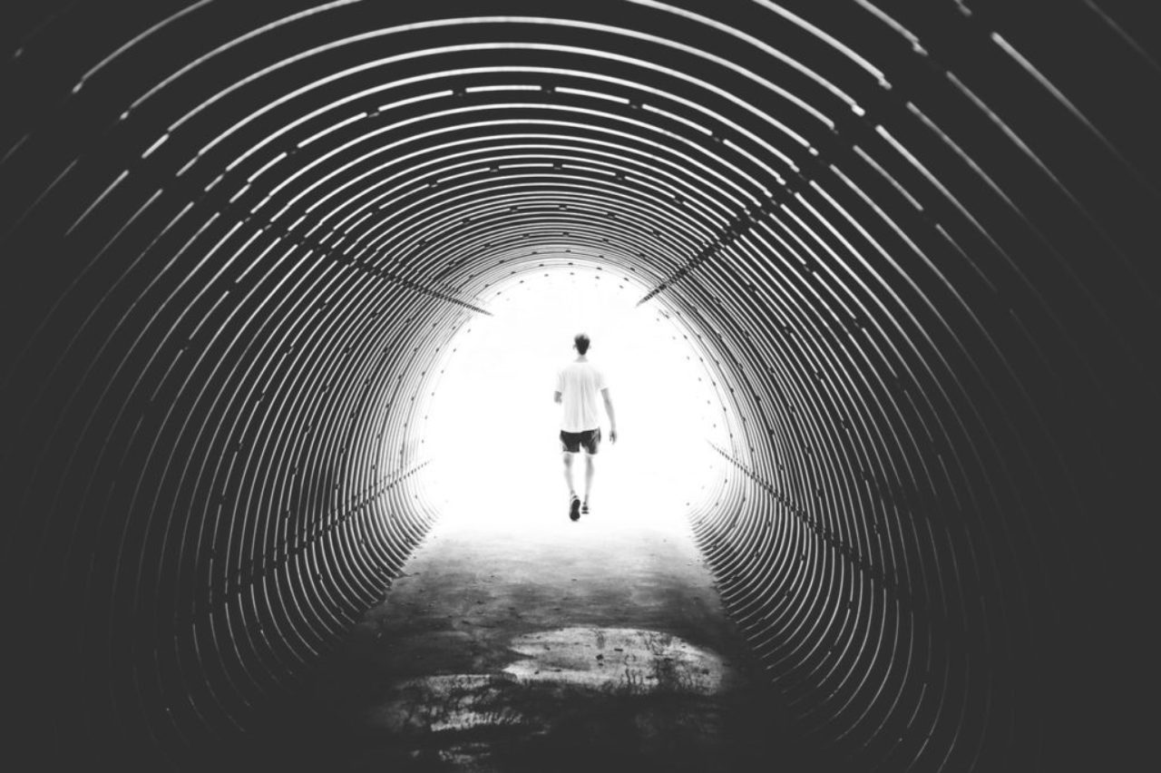 grayscale-photo-of-man-walking-in-hole-172738/