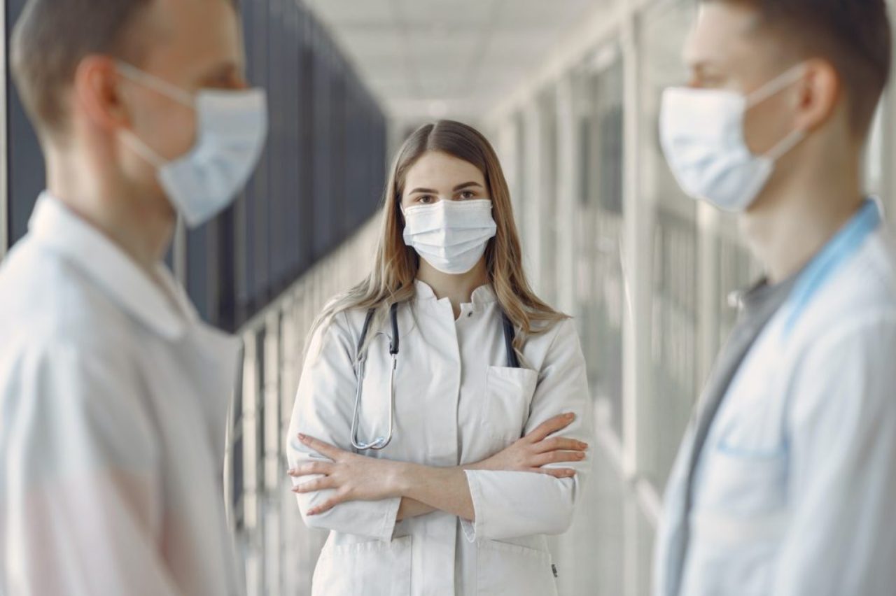 woman-in-white-coat-wearing-white-face-mask-3985163