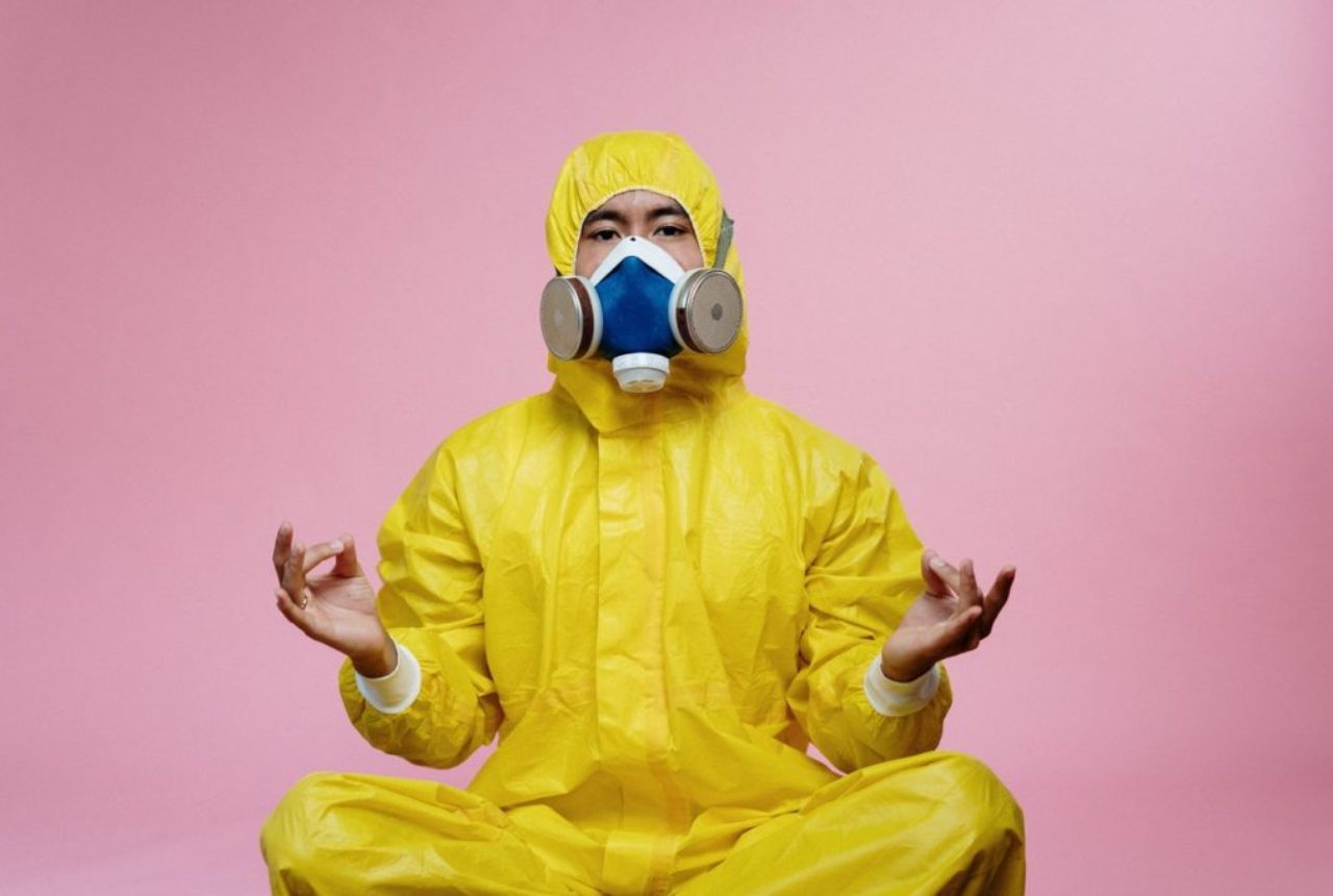 person-in-yellow-protective-suit-doing-a-yoga-pose-3951367