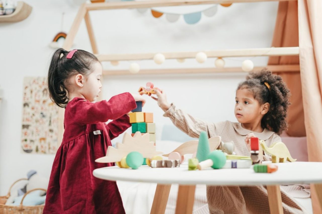 girl-in-red-dress-playing-a-wooden-blocks