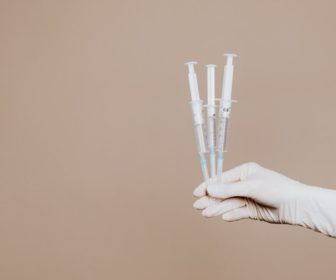 person-holding-three-syringes-with-medicine