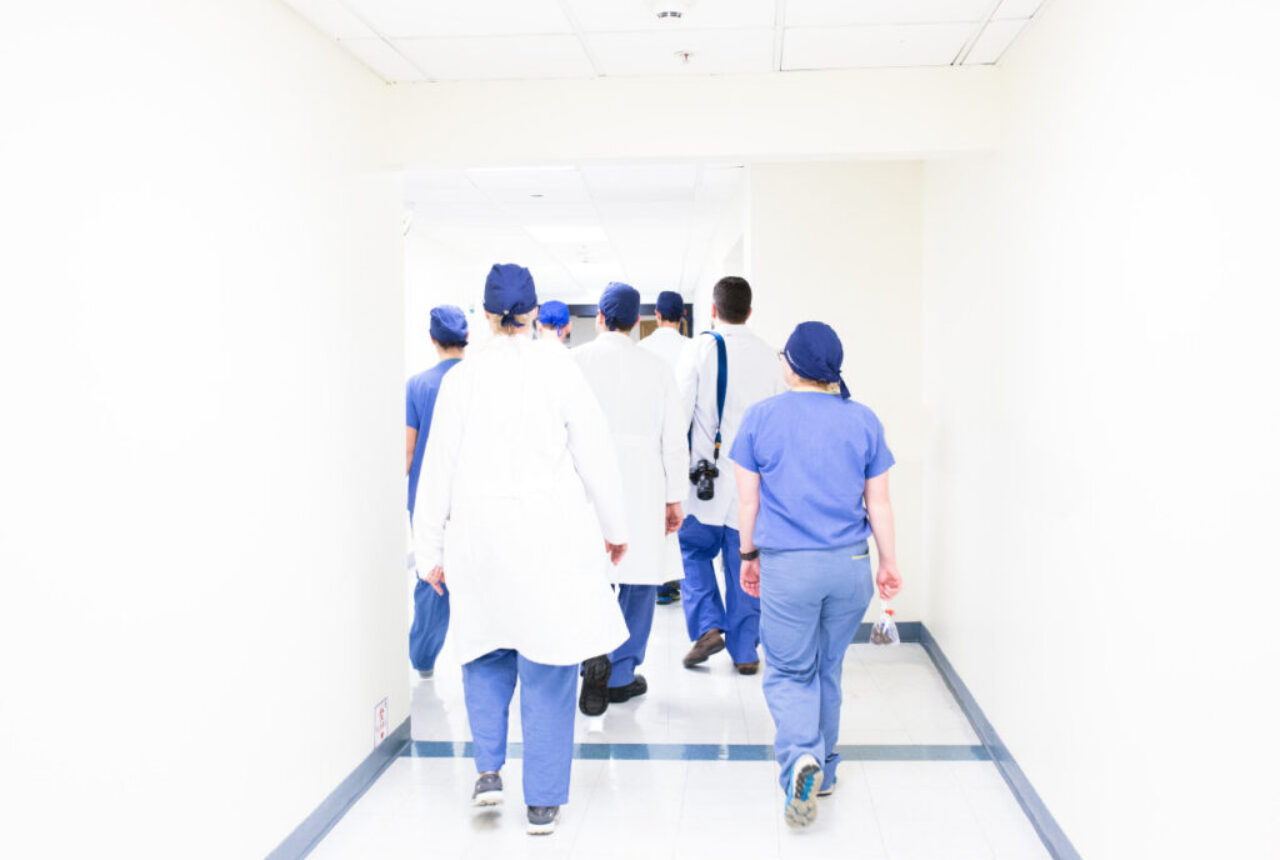 Hospital staff walking down hallway